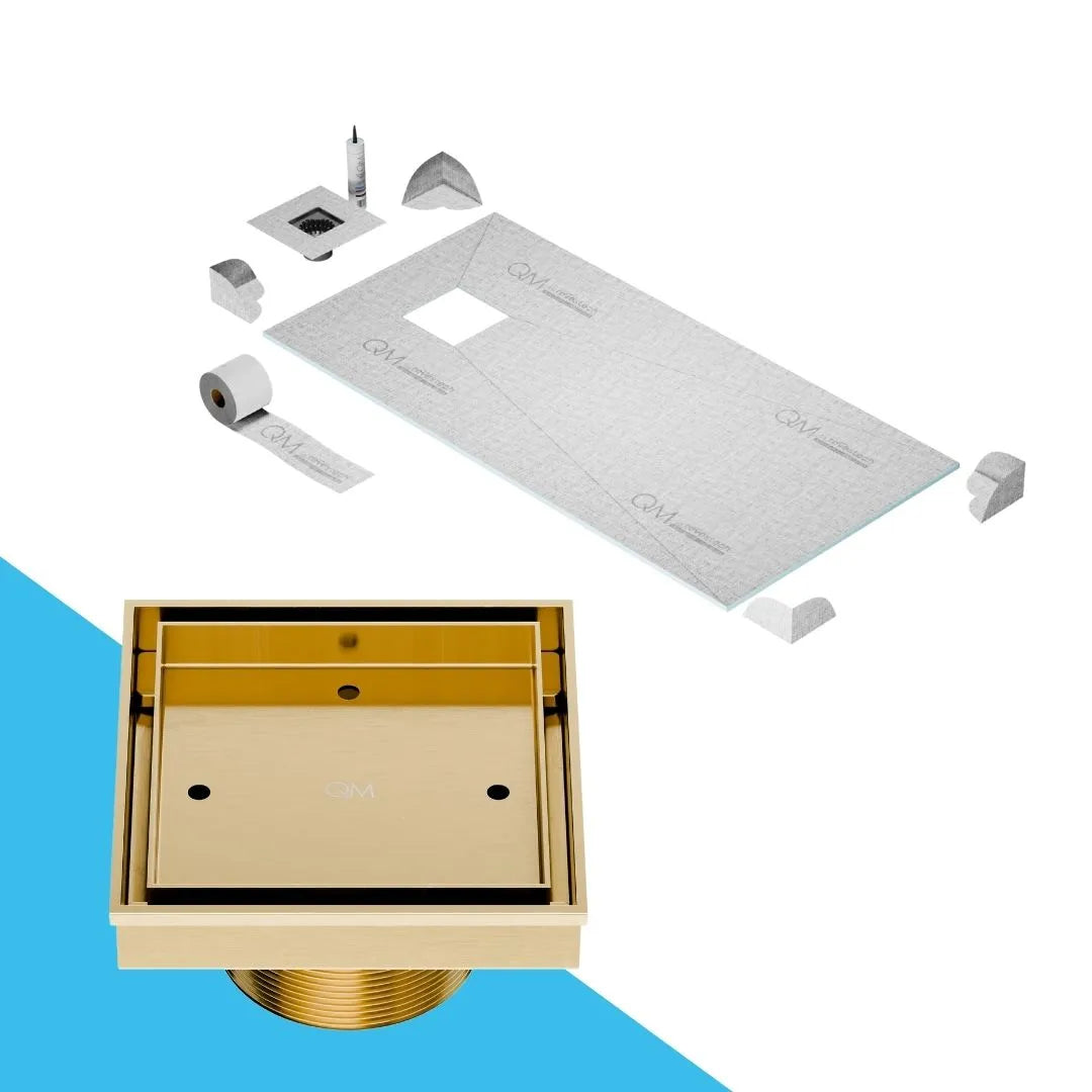 QM Drain Prefab Shower Curbless Mist Tile-In Off Center Square Drain 4x4 in Gold finish, featuring a stainless-steel channel with 'mist' perforated grate design. This drain allows seamless tile integration, offering efficient water drainage and a modern, minimalist aesthetic for luxury curbless shower installations.