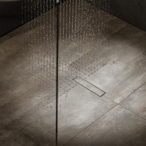 QM Drain Lagos Veil Tile-In Banner, showcasing a sleek stainless-steel linear drain with a concealed grate design for seamless tile integration. The banner highlights efficient water drainage, minimalist aesthetics, and modern style, ideal for luxury shower and bathroom floor installations.