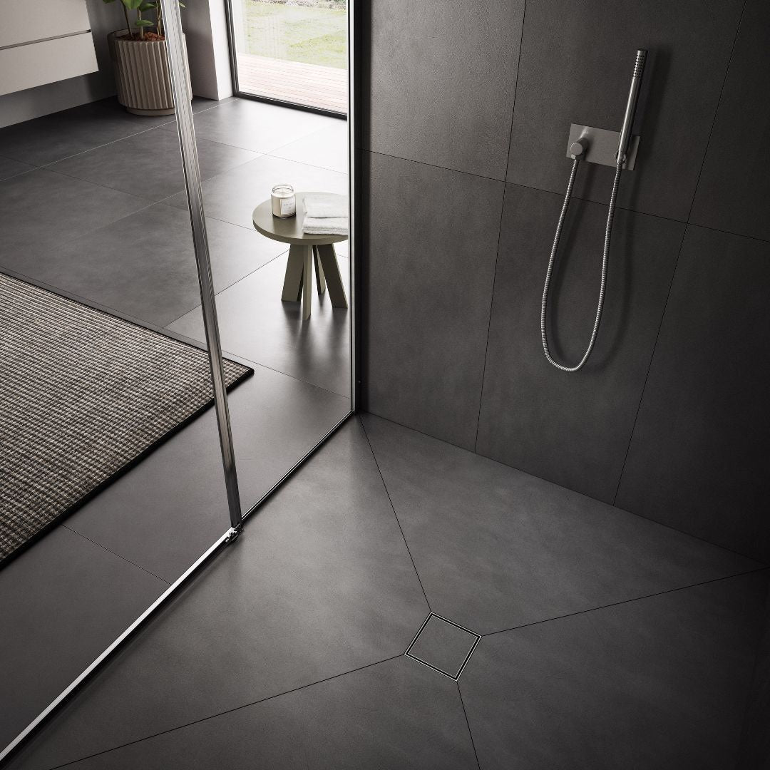 QM Drain Mist Tile-In Square Drain installed in a modern shower, featuring a sleek stainless-steel channel with fine perforated ‘mist’ grate. The drain seamlessly integrates with the tiled floor, offering efficient water drainage and a minimalist aesthetic, perfect for luxury bathroom installations.