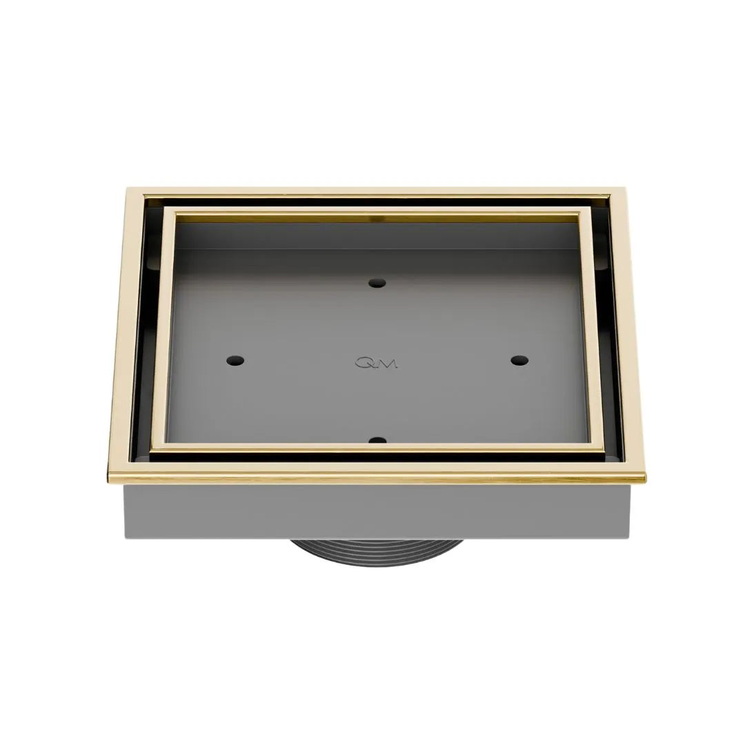 QM Drain Lagos Veil (Tile-In) Square Drain 5¾” in Gold finish, featuring a sleek stainless-steel channel with a concealed grate design. This drain allows seamless tile integration, providing efficient water drainage while maintaining a modern, minimalist aesthetic for high-end shower and bathroom installations.