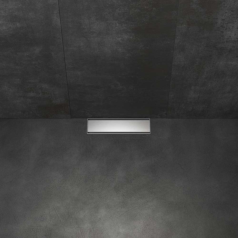 QM Drain Supreme Tile-In+ Drain installed in a modern shower, showcasing a sleek stainless-steel channel with seamless tile integration. The drain provides efficient water drainage and a minimalist aesthetic, perfect for luxury bathroom and shower floor installations.