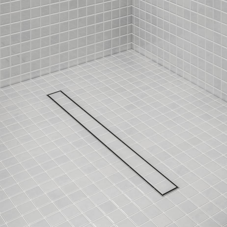 Bay 2-in-1 Linear Drain by QM Drain installed in a contemporary shower. Reversible grate shown in use, blending seamlessly with large-format tiles for efficient drainage and minimalist design.