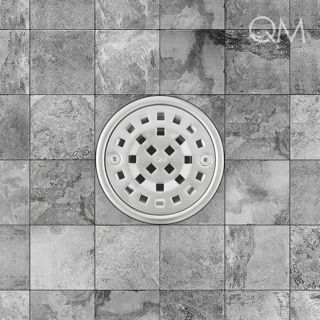 Rounded stainless-steel tile-in drain positioned at center, featuring sleek grate design, integrated waterproofing flange, and efficient high-flow drainage for upscale bathroom aesthetics.