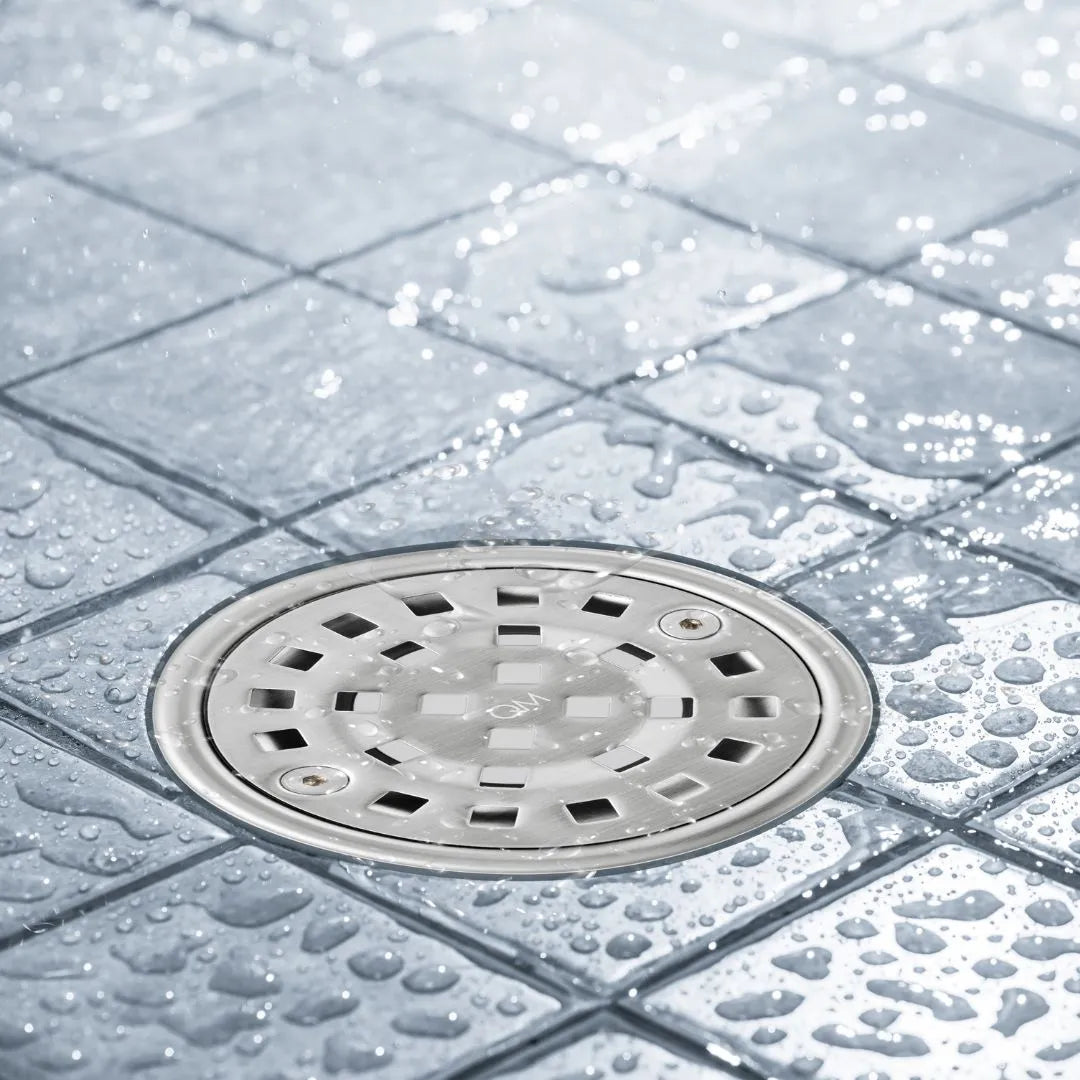 Bay Ria Round Center Drain by QM Drain installed in a modern shower. Stainless steel drain integrated into tiled floor, providing efficient water flow and sleek bathroom aesthetics.