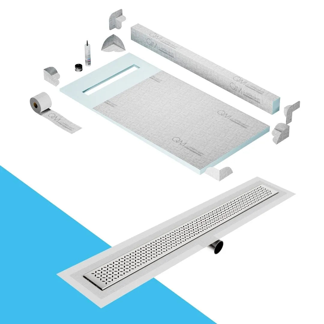 QM Drain Curb Shower Pan with Delmar Lotus Side Outlet Linear Drain, stainless-steel decorative floral-pattern grate, ensuring efficient drainage, available in Satin, Gold, Bronze, Polished, and Black finishes.