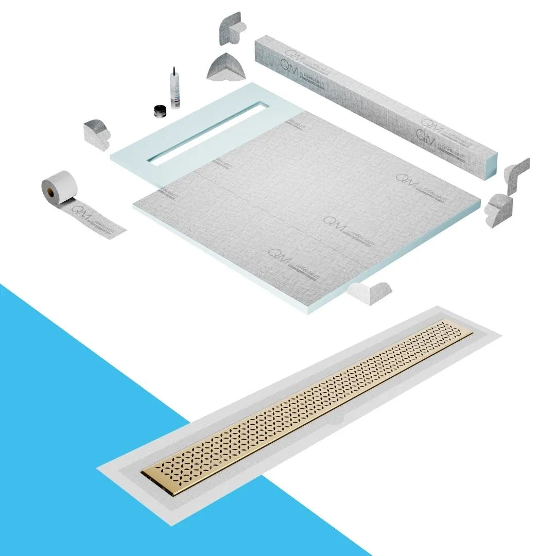 QM Drain Curb Shower Pan with Delmar Lotus Flange Edge Linear Drain, stainless-steel decorative floral grate design, integrated flange for seamless tile installation, efficient drainage, offered in Satin, Gold, Bronze, Polished, and Black finishes.