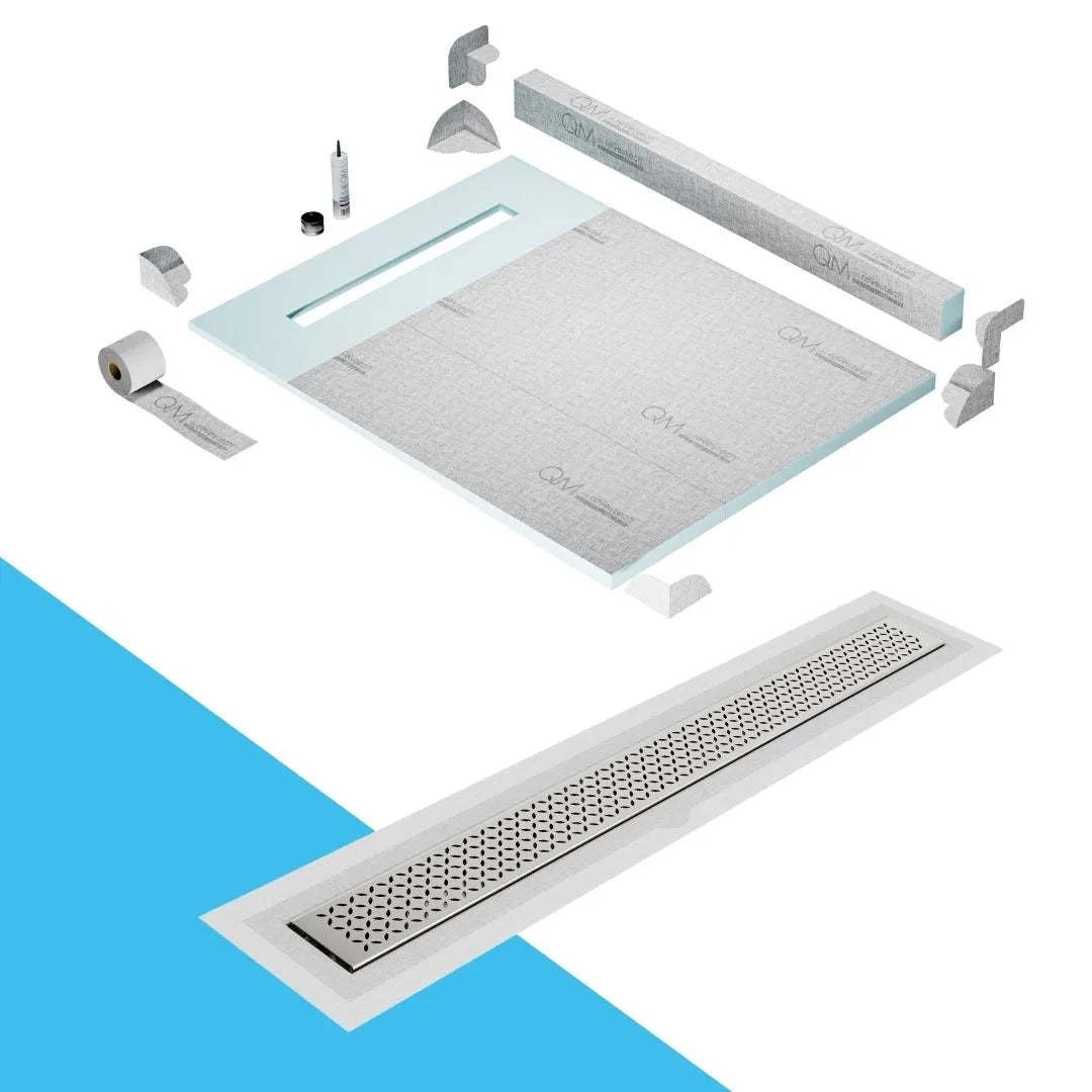 QM Drain Curb Shower Pan with Delmar Lotus Flange Edge Linear Drain, stainless-steel decorative floral grate design, integrated flange for seamless tile installation, efficient drainage, offered in Satin, Gold, Bronze, Polished, and Black finishes.