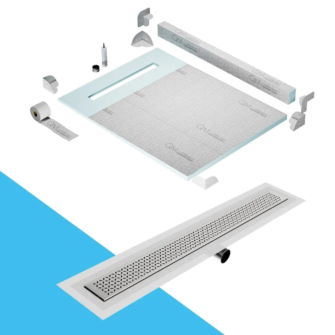 QM Drain Curb Shower Pan with Delmar Lotus Side Outlet Linear Drain, stainless-steel decorative floral-pattern grate, ensuring efficient drainage, available in Satin, Gold, Bronze, Polished, and Black finishes.
