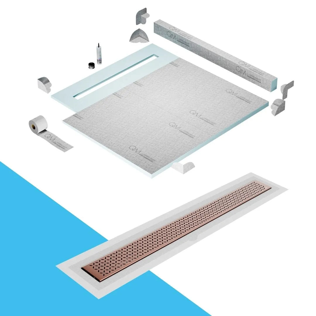 QM Drain Curb Shower Pan with Delmar Lotus Flange Edge Linear Drain, stainless-steel decorative floral grate design, integrated flange for seamless tile installation, efficient drainage, offered in Satin, Gold, Bronze, Polished, and Black finishes.