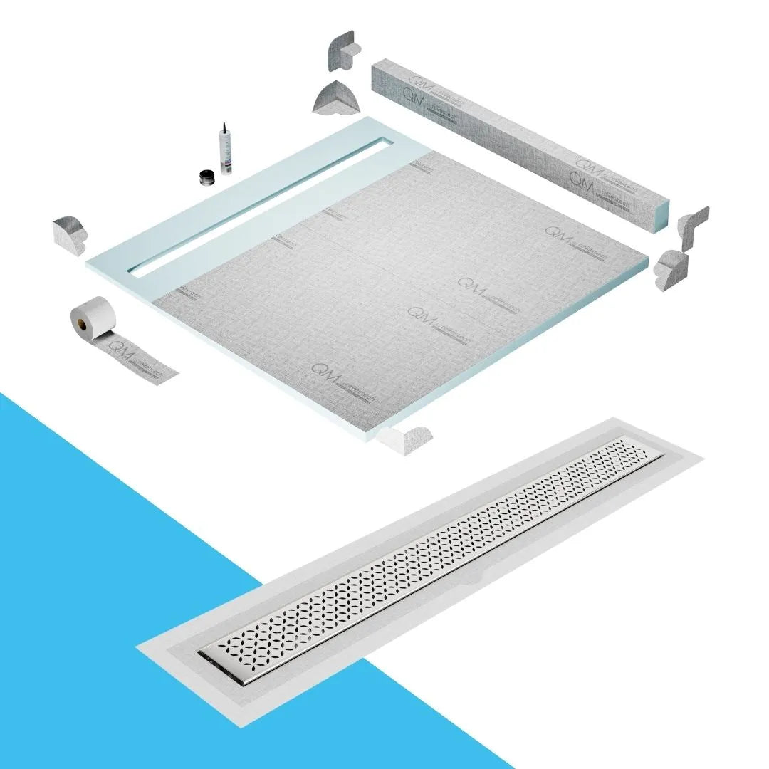 QM Drain Curb Shower Pan with Delmar Lotus Flange Edge Linear Drain, stainless-steel decorative floral grate design, integrated flange for seamless tile installation, efficient drainage, offered in Satin, Gold, Bronze, Polished, and Black finishes.