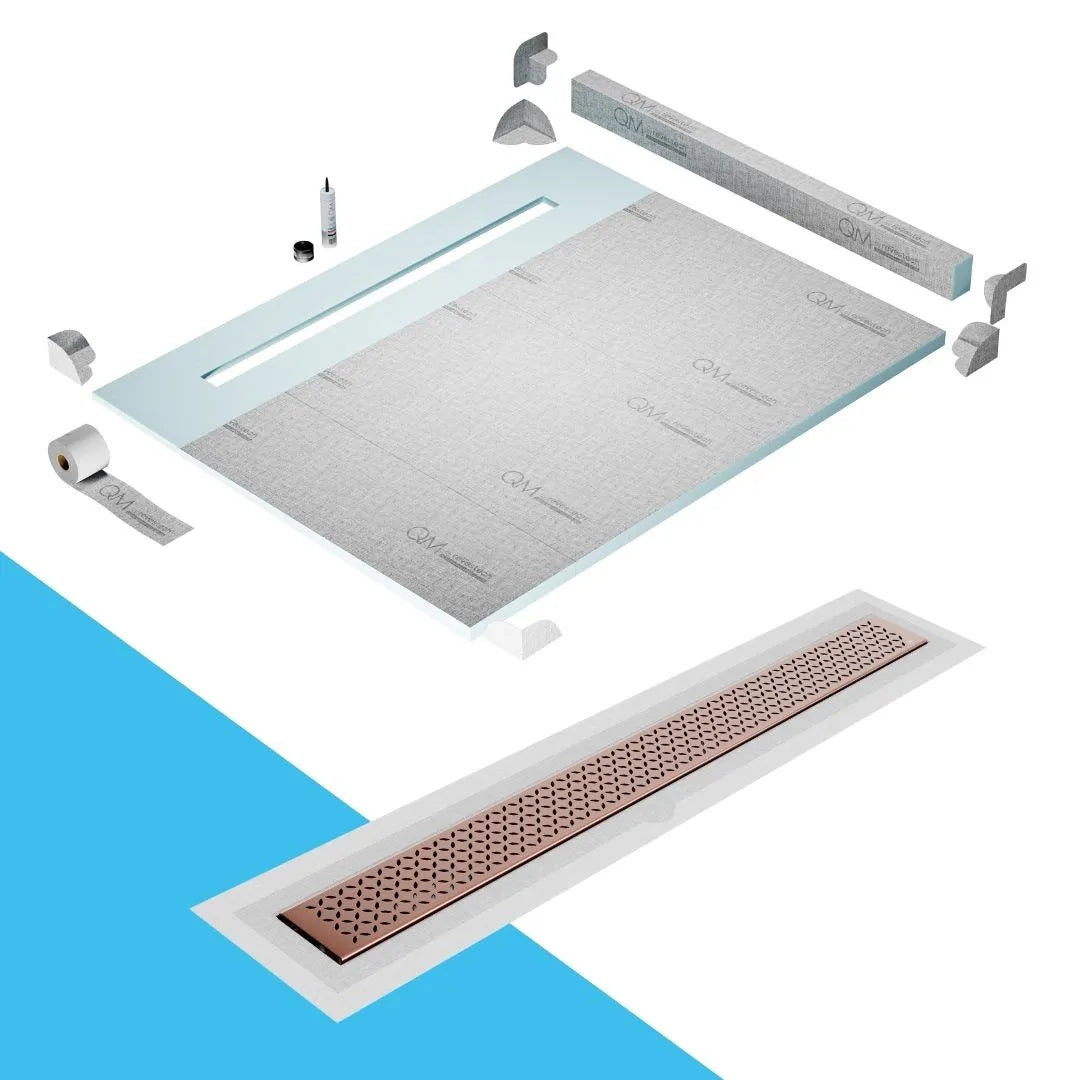 QM Drain Curb Shower Pan with Delmar Lotus Flange Edge Linear Drain, stainless-steel decorative floral grate design, integrated flange for seamless tile installation, efficient drainage, offered in Satin, Gold, Bronze, Polished, and Black finishes.