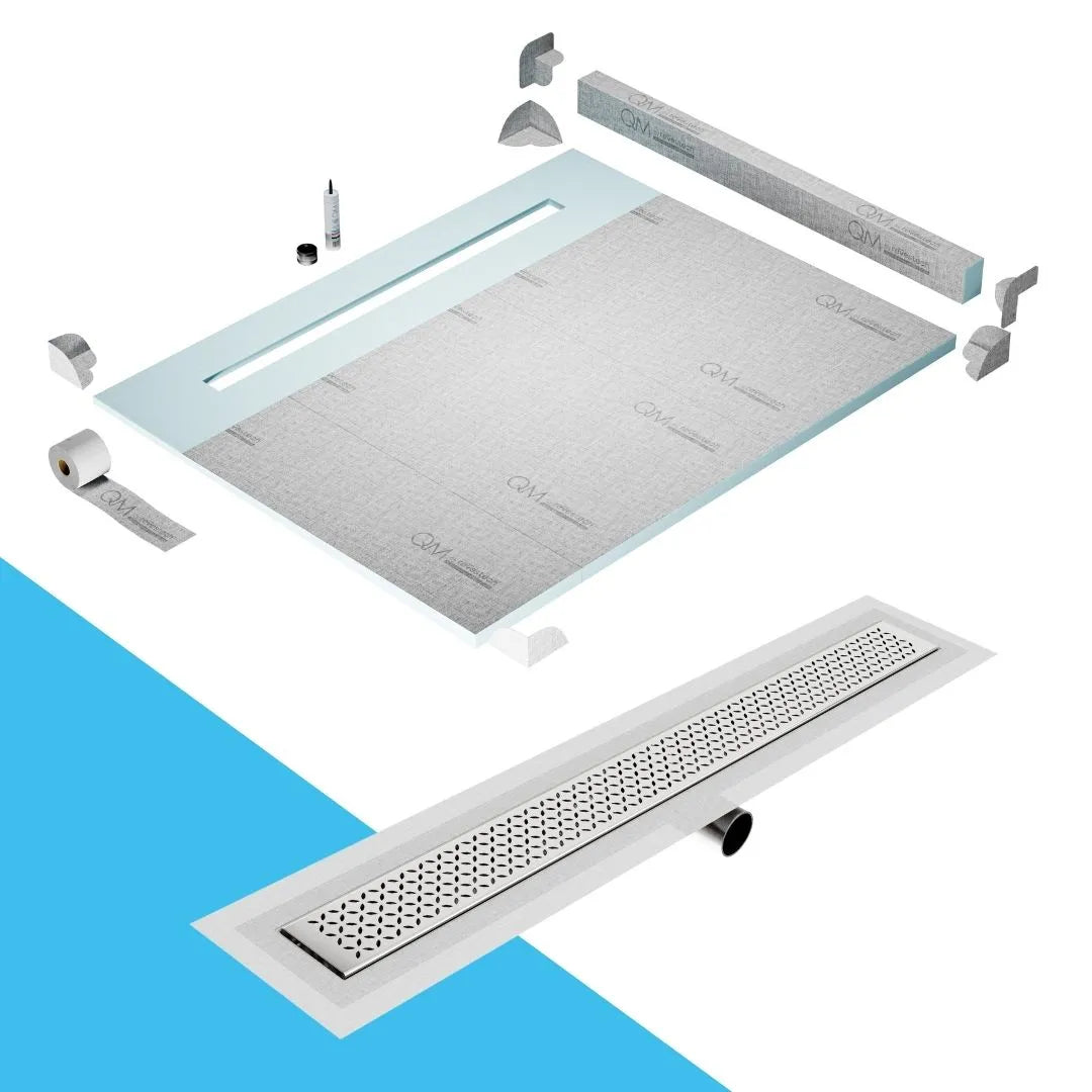 QM Drain Curb Shower Pan with Delmar Lotus Side Outlet Linear Drain, stainless-steel decorative floral-pattern grate, ensuring efficient drainage, available in Satin, Gold, Bronze, Polished, and Black finishes.