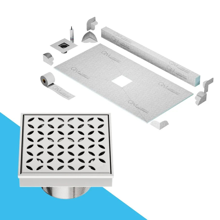 QM Drain Curb Shower Pan with Delmar Lotus Center Square Drain, stainless-steel floral-pattern grate, available in Satin, Gold, Bronze, Polished, and Black finishes, offering elegant aesthetics and effective water drainage for luxury bathrooms.
