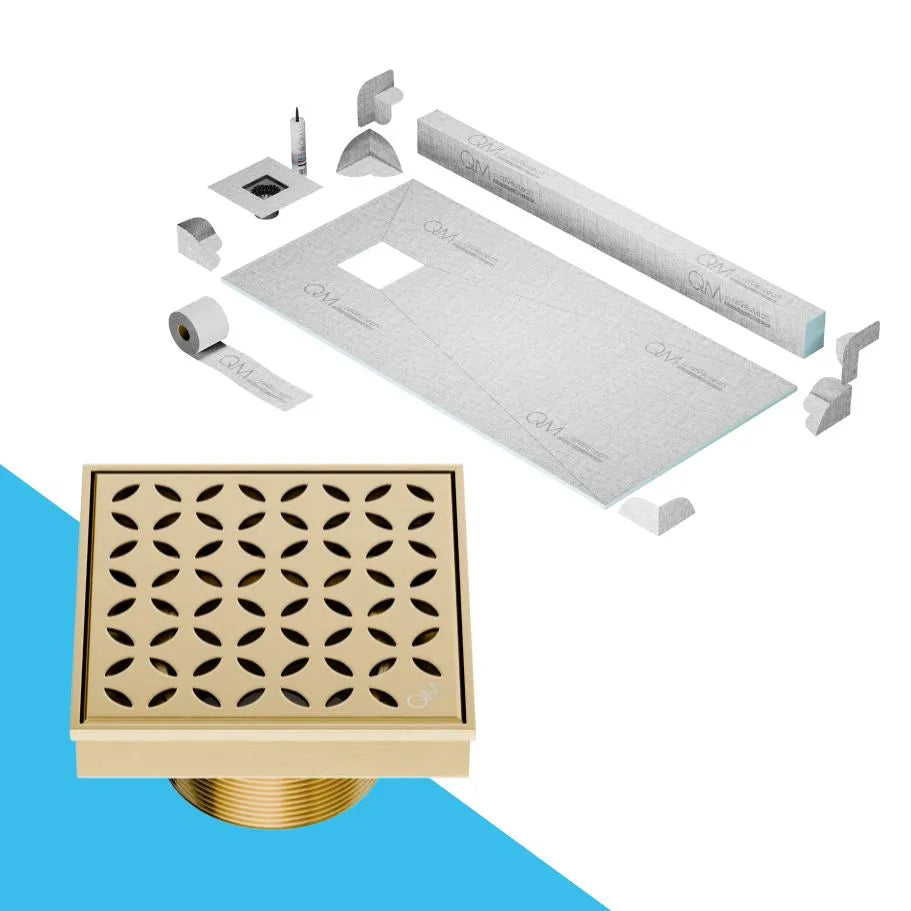 QM Drain curb Shower Pan with Delmar Lotus Off-Center Square Drain, elegant floral-pattern stainless-steel grate, stylish, efficient drainage, offered in Satin, Gold, Bronze, Polished, and Black finishes.