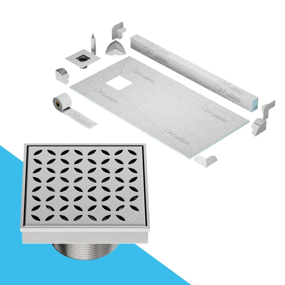 QM Drain curb Shower Pan with Delmar Lotus Off-Center Square Drain, elegant floral-pattern stainless-steel grate, stylish, efficient drainage, offered in Satin, Gold, Bronze, Polished, and Black finishes.