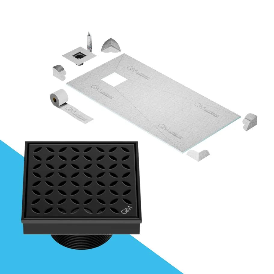 QM Drain Curbless Shower Pan with Delmar Lotus Off Center Square Drain, stainless-steel floral-pattern grate, available in Satin, Gold, Bronze, Polished, and Black finishes, offering elegant aesthetics and effective water drainage for luxury bathrooms.
