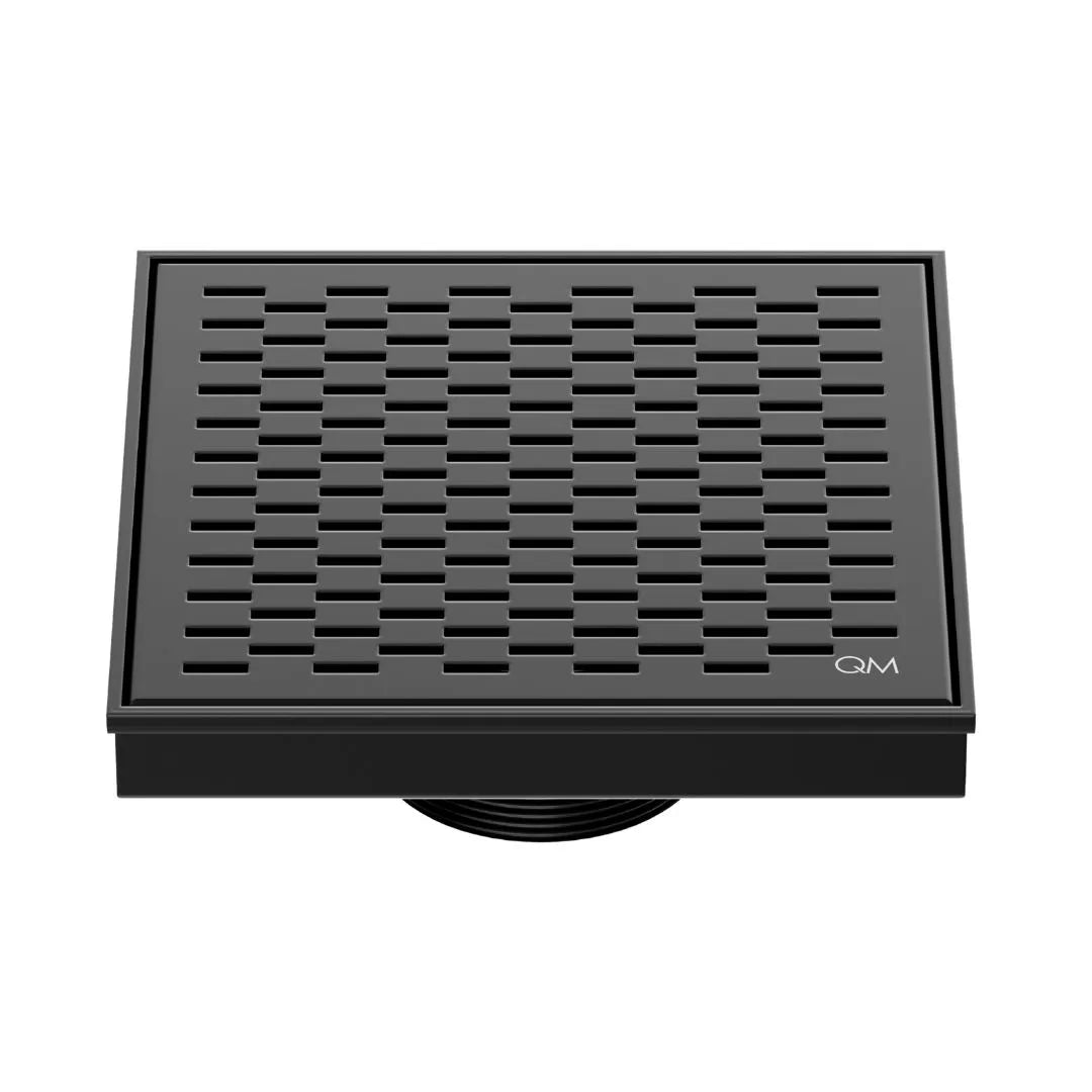 QM Drain Delmar Delta Square Drain 5 3/4-inch in Black finish, featuring a sleek stainless-steel square-pattern grate. This drain ensures efficient water drainage, seamless tile integration, and a modern, minimalist aesthetic, perfect for luxury shower and bathroom floor installations.