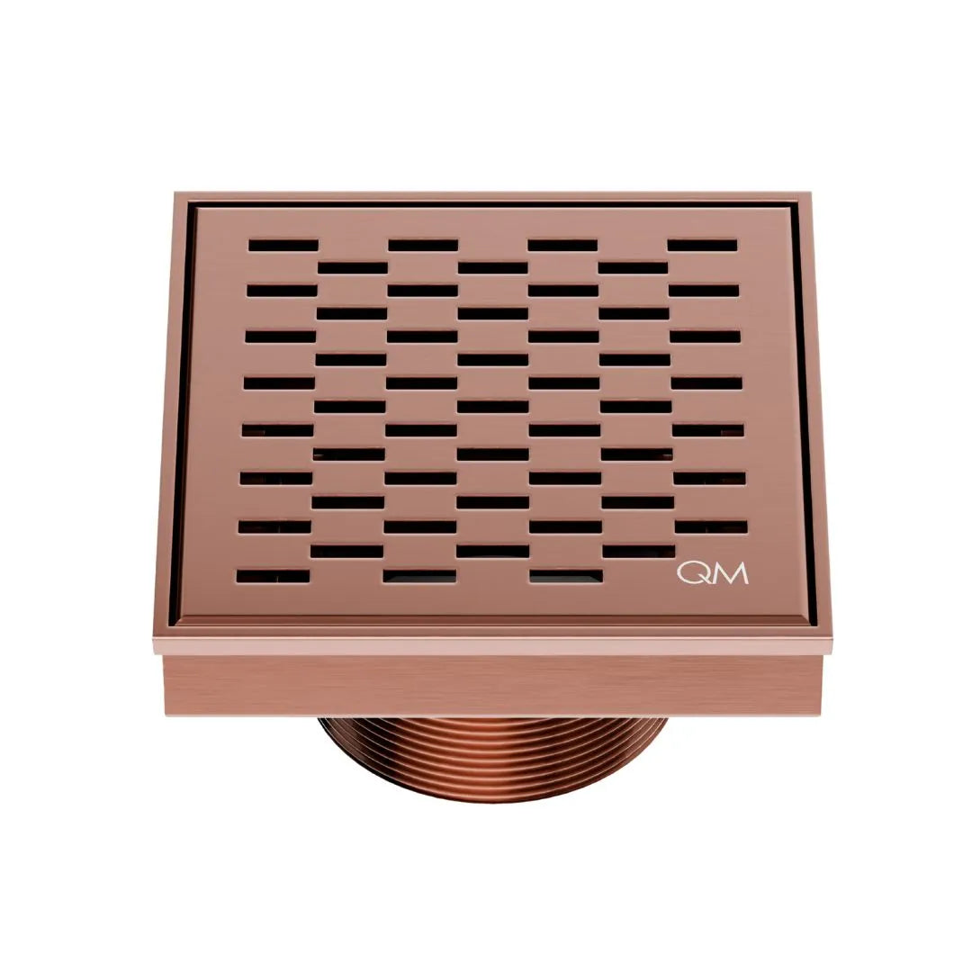 QM Drain Delmar Delta Square Drain 4x4-inch in Bronze finish, featuring a sleek stainless-steel square-pattern grate. This drain provides efficient water drainage, seamless tile integration, and an elegant aesthetic, ideal for luxury shower and bathroom floor installations.