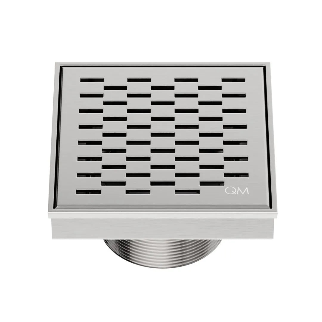 QM Drain Delmar Delta Square Drain 4x4-inch in Satin finish, featuring a sleek stainless-steel square-pattern grate. This drain provides efficient water drainage, seamless tile integration, and a high-end polished aesthetic, perfect for luxury shower and bathroom floor installations.