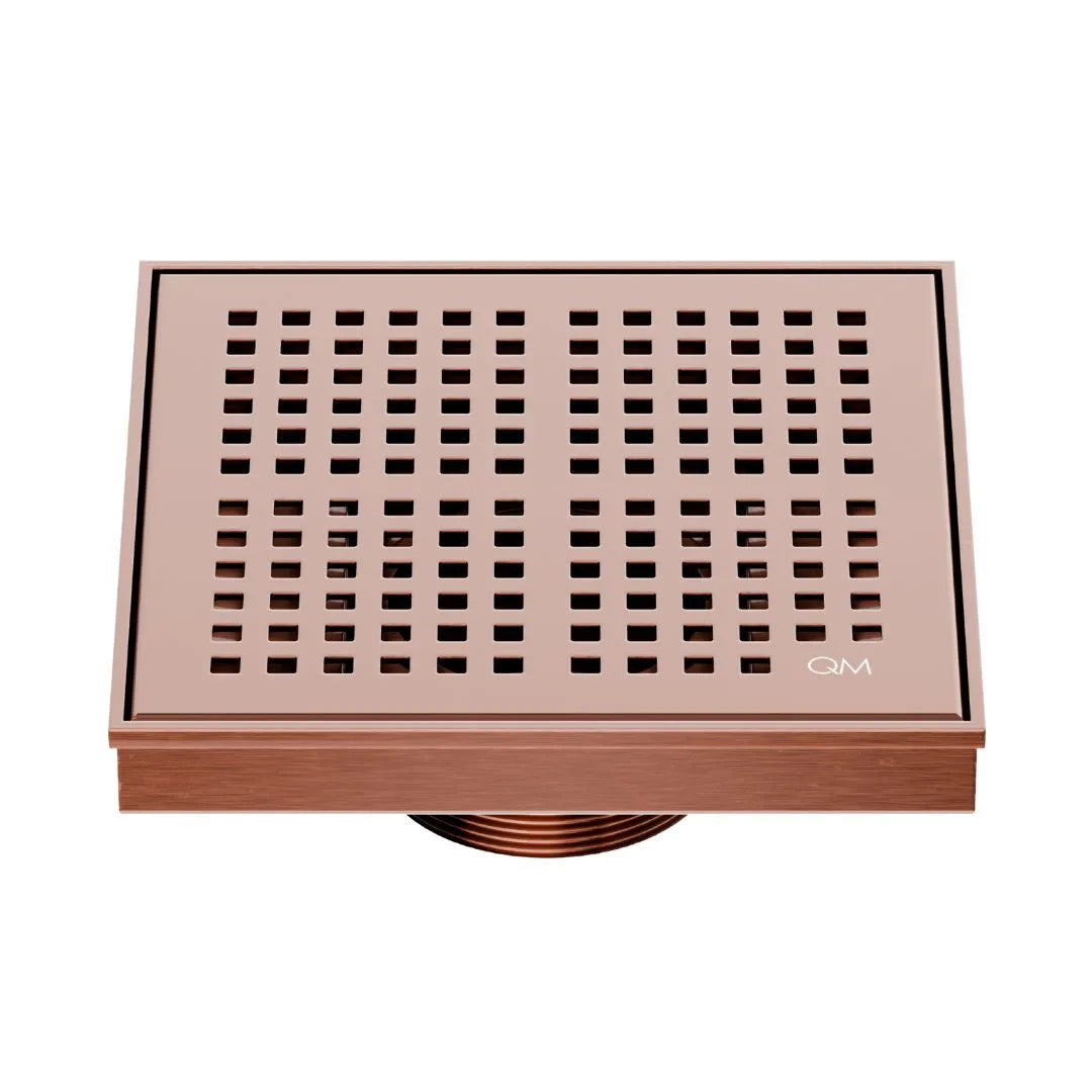 QM Drain Delmar Kai Square Drain 5 3/4-inch in Bronze finish, featuring a sleek stainless-steel grate with fine square perforations. This drain ensures efficient water drainage, seamless tile integration, and an elegant aesthetic, ideal for luxury shower and bathroom floor installations.