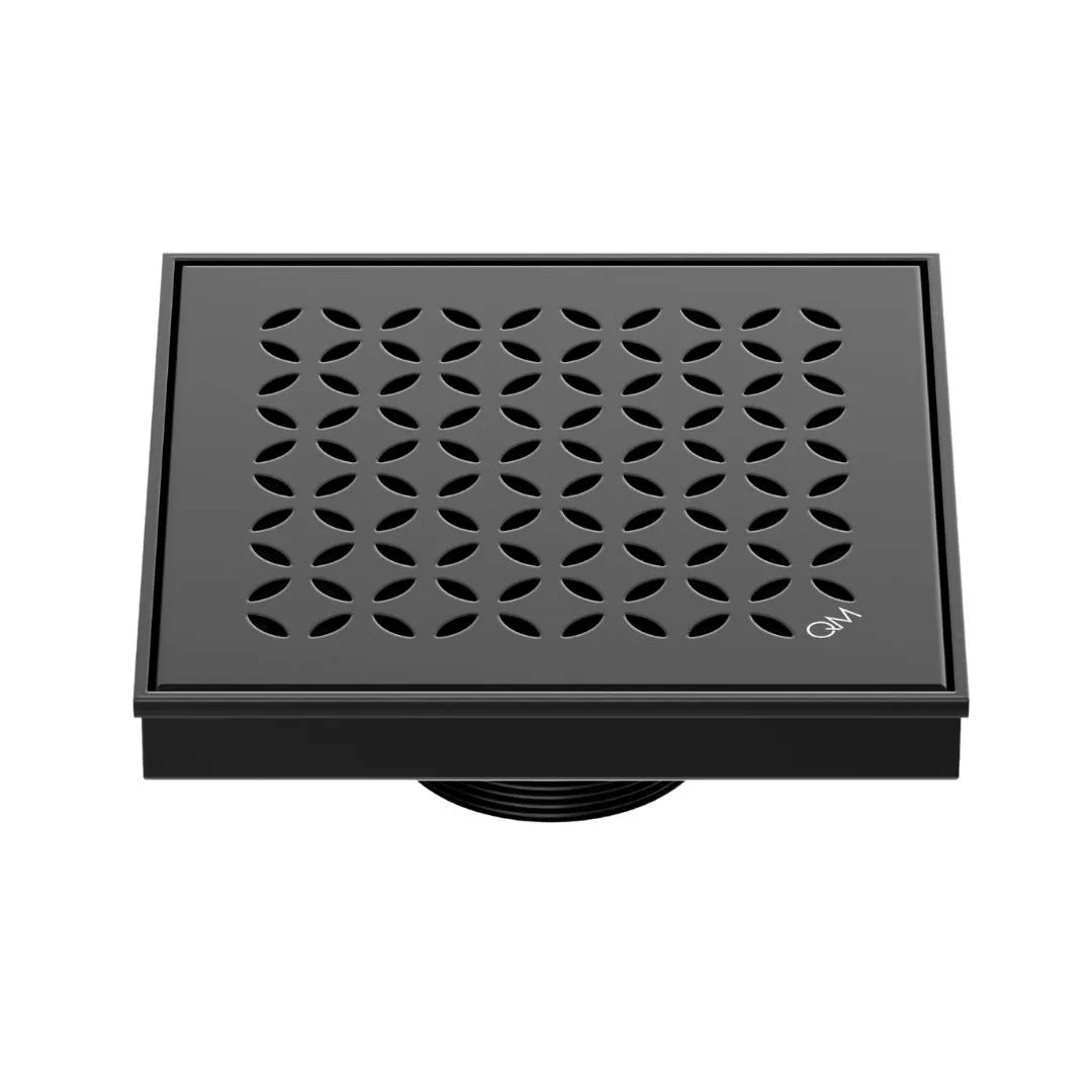 QM Drain Delmar Lotus Square Drain 5 3/4-inch, featuring a sleek stainless-steel channel with an elegant floral-pattern grate. This drain provides efficient water drainage, seamless tile integration, and a luxurious aesthetic, perfect for high-end shower and bathroom floor installations.