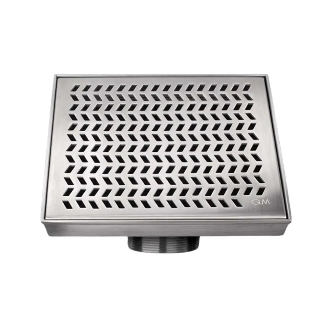 QM Drain Delmar Nami Square Drain 2-inch, featuring a sleek stainless-steel channel with a modern perforated grate design. This drain ensures efficient water drainage, seamless tile integration, and a contemporary aesthetic, ideal for luxury shower and bathroom floor installations.