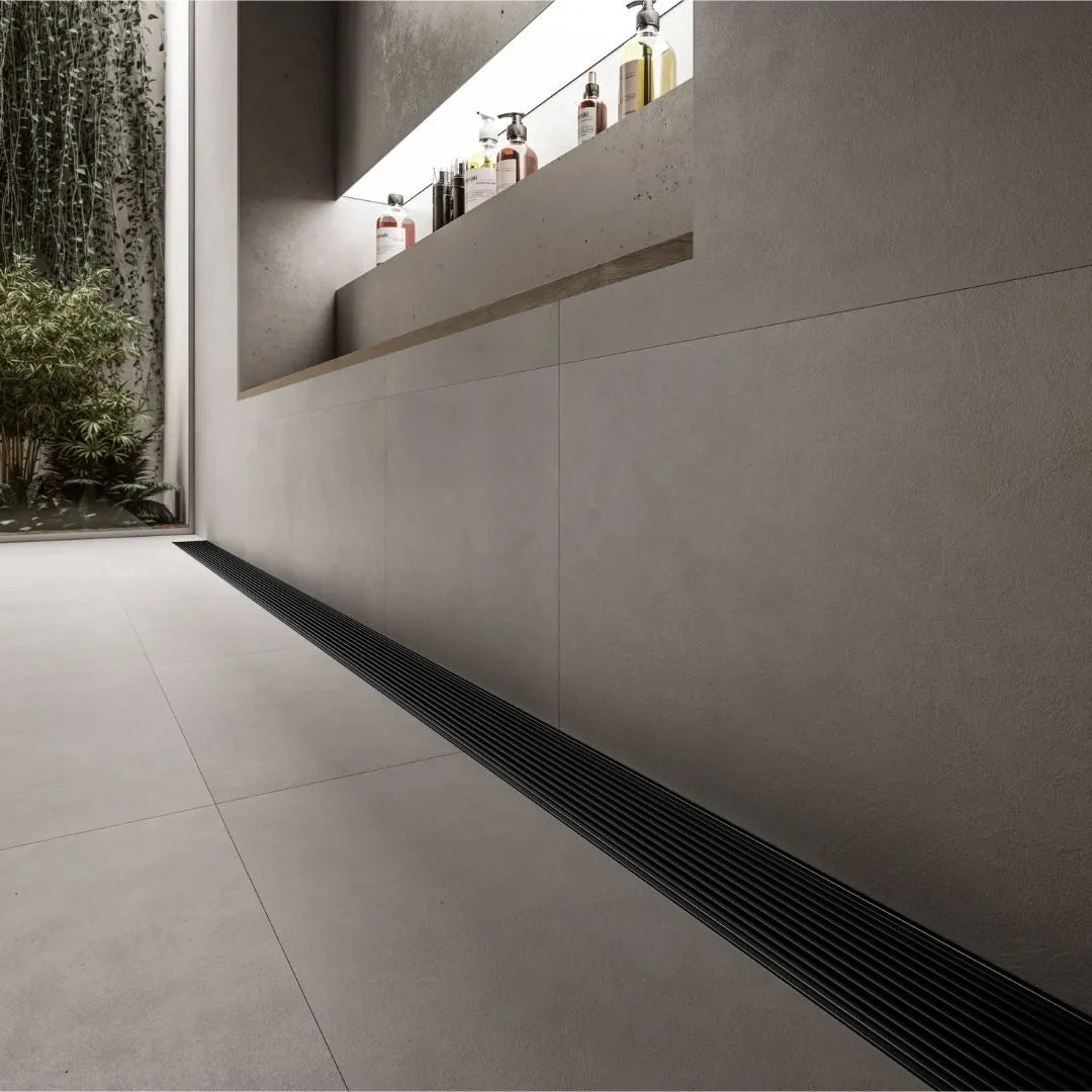 Modern shower floor showcasing the QM Drain Adjustable Wedgewire Linear Drain—stainless-steel channel with corrosion-resistant wedge-wire grate and adjustable frame, installed flush within large-format tiles for seamless integration and efficient high-flow water.