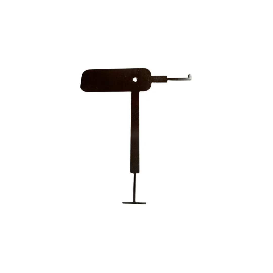 Modern bathroom scene featuring the QM Drain Invisible Drain “Tray Key” tool—a slim stainless-steel accessory designed for effortless removal and cleaning of linear drain grates, emphasizing its ergonomic shape and durable finish.