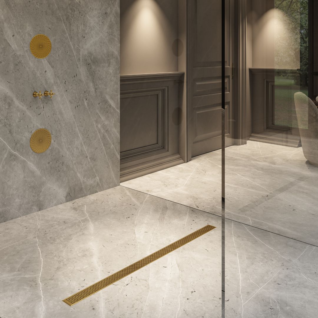 QM Drain Lotus Linear Drain in Gold finish, featuring a sleek stainless-steel channel with a perforated grate design. This drain offers efficient water drainage, seamless tile integration, and a luxurious modern aesthetic for high-end shower and bathroom installations.