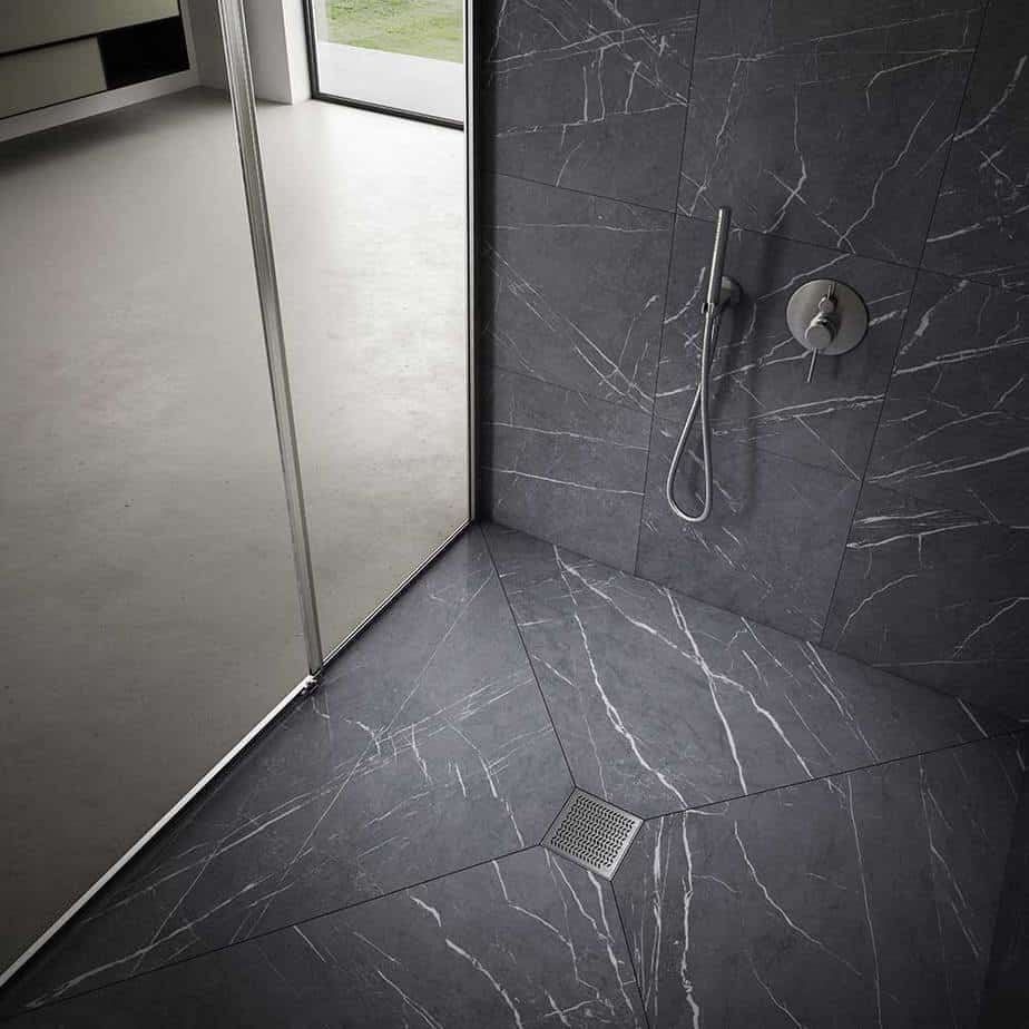 Modern shower floor showcasing the QM Drain Nami Square Drain in Satin finish—4″×4″ stainless-steel tile-in grate with minimalist lines, integrated waterproof flange, and efficient high-flow drainage for contemporary bathroom designs.
