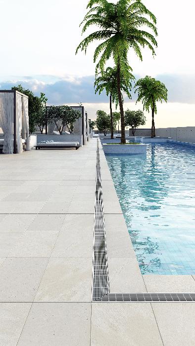 Modern poolside installation featuring the Wedgewire Delmar Adjustable Linear Drain – outdoor pool drain in durable stainless-steel with black finish, adjustable-length channel, corrosion-resistant wedge-wire grate, and integrated flange for efficient perimeter water management and sleek design.