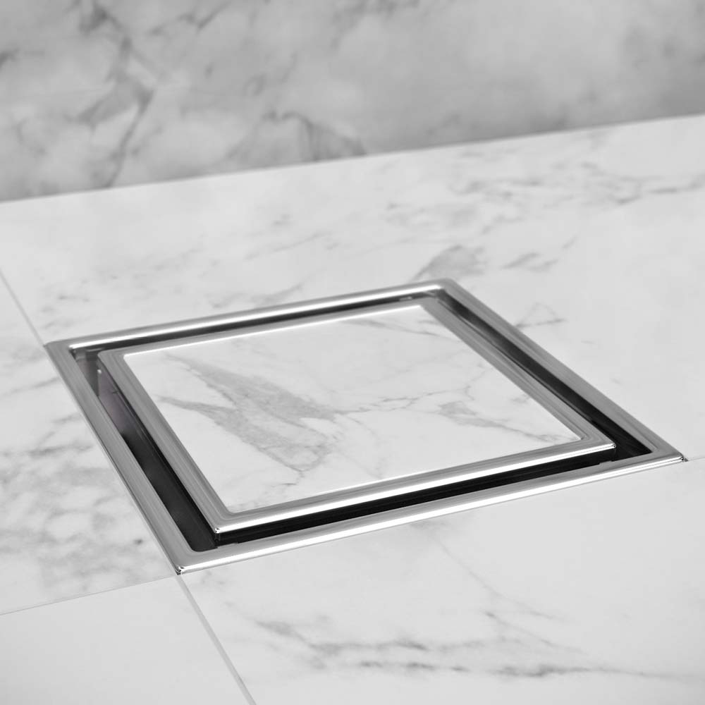 QM Drain Lagos Veil Tile-In Square Drain, featuring a sleek stainless-steel channel with a concealed grate design. This drain offers efficient water drainage, seamless integration with tile floors, and a modern minimalist aesthetic, perfect for luxury shower and bathroom installations.