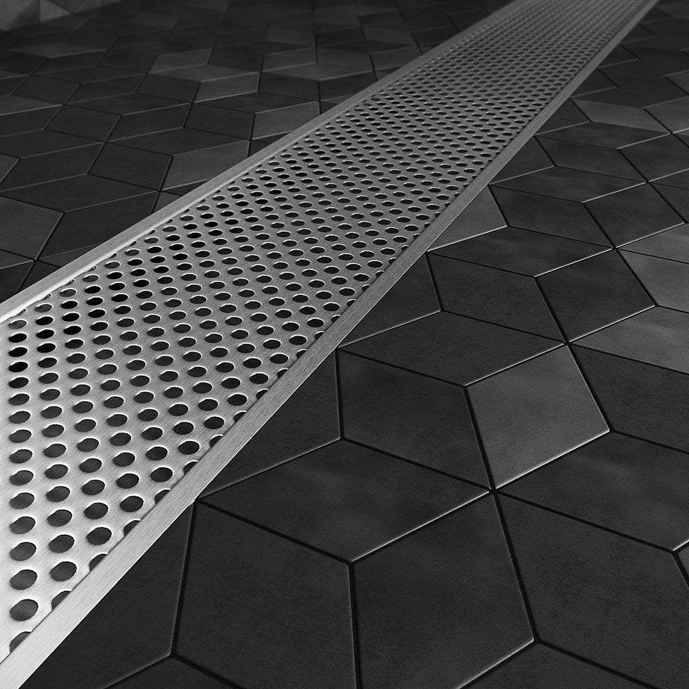 Modern shower floor showcasing the Perforated Adjustable Kit Lagos Linear Drain with 2″ outlet—stainless-steel adjustable-length channel with precision perforated grate, integrated waterproof flange beneath surrounding tiles, and versatile on-site frame for efficient, customizable water drainage in luxury bathrooms.