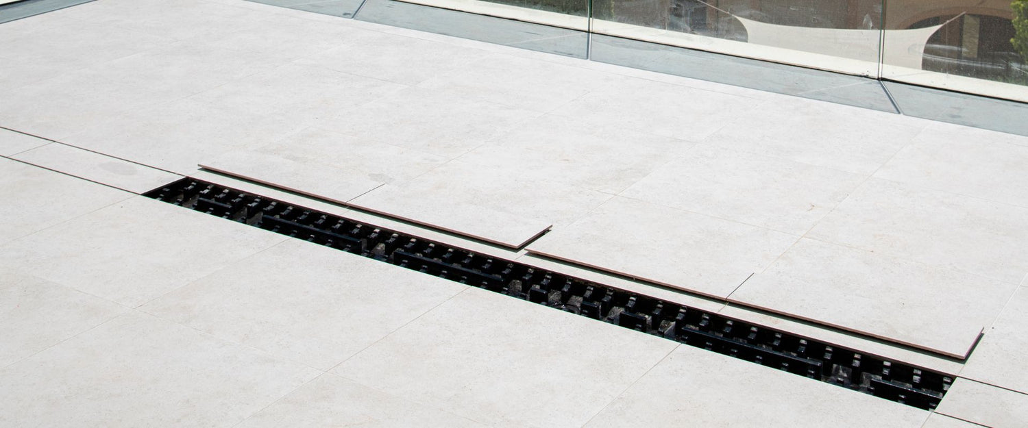 Banner showing an Invisible Linear Drain seamlessly integrated into a modern bathroom floor, highlighting its hidden design, low-profile structure, and durable polyurethane with polyurea coating.