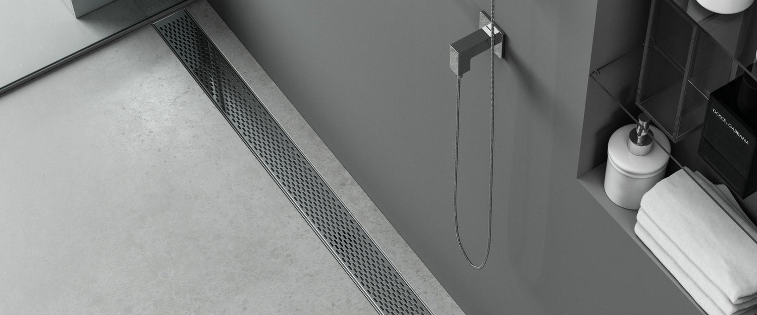 Banner showing a Delta Linear Drain installed in a bathroom floor, highlighting premium stainless steel construction, sleek modern design, and durable performance by QM Drain.