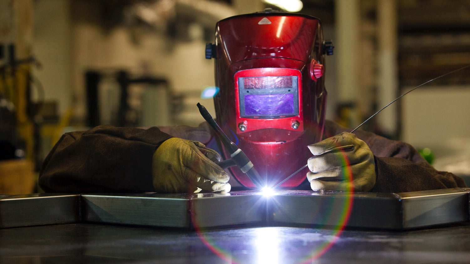 Factory specialist welding steel parts of QM Drain’s shower drain components, highlighting precision craftsmanship and industrial manufacturing.
