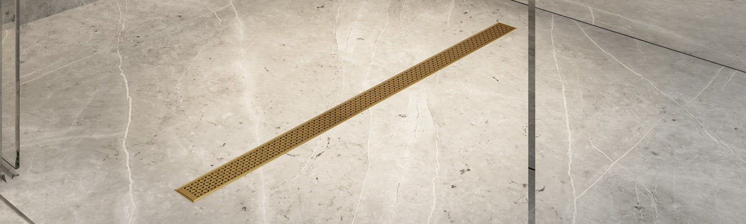 Banner featuring a Delmar Series shower drain installed in a modern bathroom floor, highlighting premium stainless steel construction, sleek lines, and superior drainage performance by QM Drain.