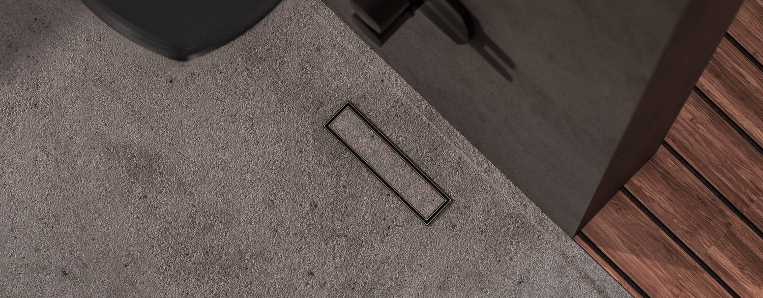 Banner showing a Lagos Series shower drain installed in a contemporary bathroom floor, highlighting sleek stainless steel design, premium craftsmanship, and modern style by QM Drain.