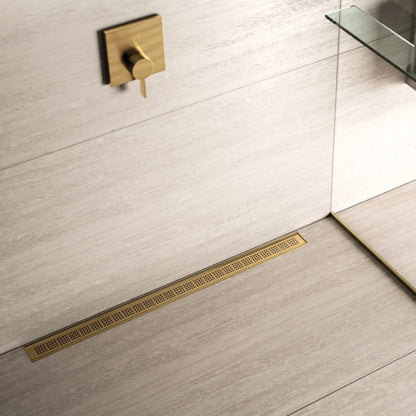 QM Drain Ria Linear Drain installed in Gold, Black, and Polished finishes, showcasing sleek stainless-steel channels with a modern perforated grate design. This drain provides efficient water drainage and seamless integration into luxury shower floors, offering a sophisticated, minimalist aesthetic.