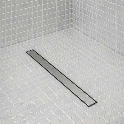 Bay 2-in-1 Linear Drain by QM Drain installed in a modern shower. Reversible grate design blends with tile floor, offering clean aesthetics and efficient water drainage.