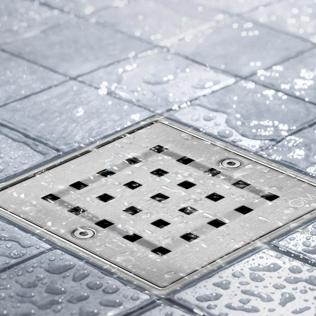 Bay Ria Square Drain by QM Drain installed in a modern shower setting. Stainless steel square grate integrated into tile floor for clean aesthetics and reliable drainage performance.