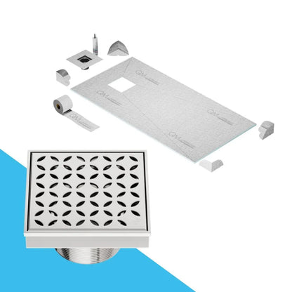 QM Drain Curbless Shower Pan with Delmar Lotus Off Center Square Drain, stainless-steel floral-pattern grate, available in Satin, Gold, Bronze, Polished, and Black finishes, offering elegant aesthetics and effective water drainage for luxury bathrooms.