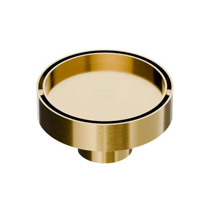 QM Drain Mist Couture Round Drain in Gold finish, available in 4”x 4” and 5 ¾”x 5 ¾” sizes. This elegant stainless-steel drain features a fine perforated circular grate, providing efficient water drainage while seamlessly integrating into modern luxury shower and bathroom installations.
