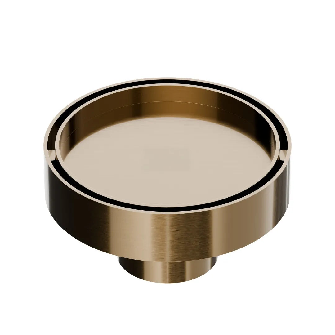 QM Drain Mist Couture Round Drain in Champagne finish, available in 4”x 4” and 5 ¾”x 5 ¾” sizes. This elegant stainless-steel drain features a fine perforated circular grate, providing efficient water drainage while seamlessly integrating into modern luxury shower and bathroom installations.