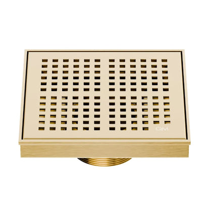 QM Drain Delmar Kai Square Drain 5 3/4-inch in Gold finish, featuring a sleek stainless-steel grate with fine square perforations. This drain provides efficient water drainage, seamless tile integration, and a luxurious aesthetic, perfect for high-end shower and bathroom floor installations.