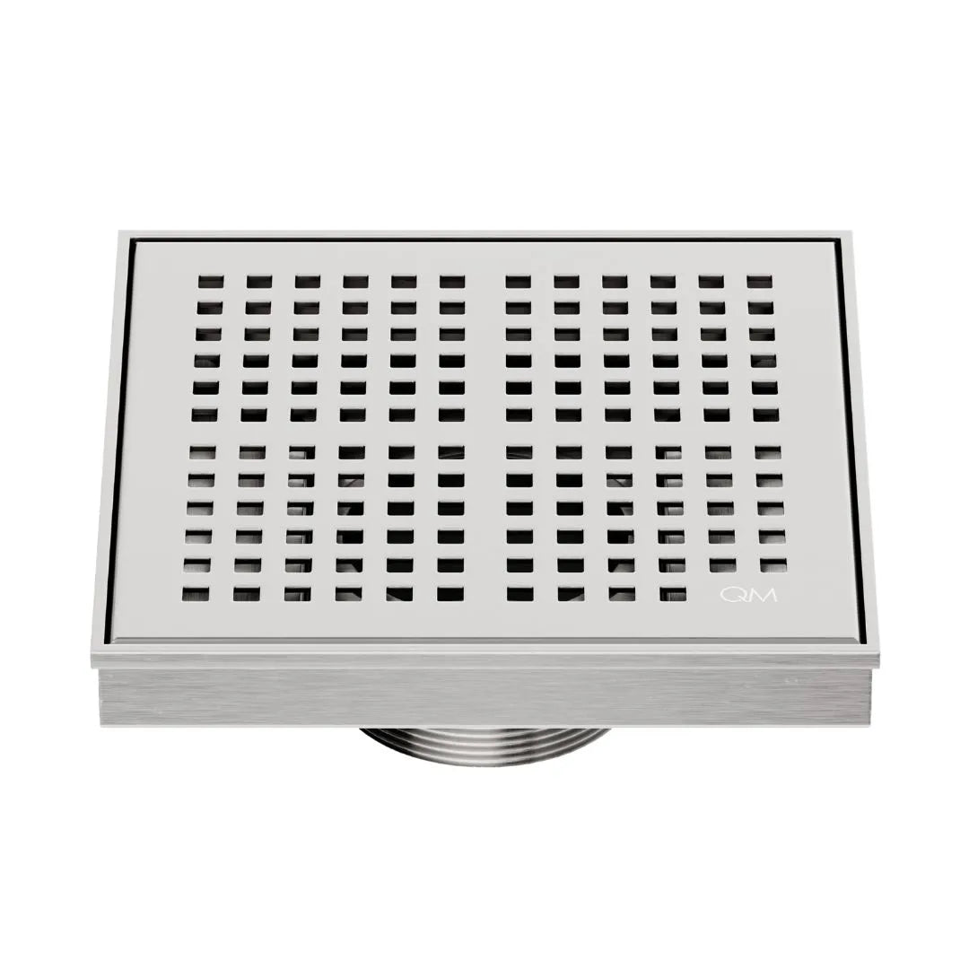 QM Drain Delmar Kai Square Drain 5 3/4-inch in Satin finish, featuring a sleek stainless-steel grate with fine square perforations. This drain offers efficient water drainage, seamless tile integration, and a high-end polished aesthetic, ideal for luxury shower and bathroom floor installations.