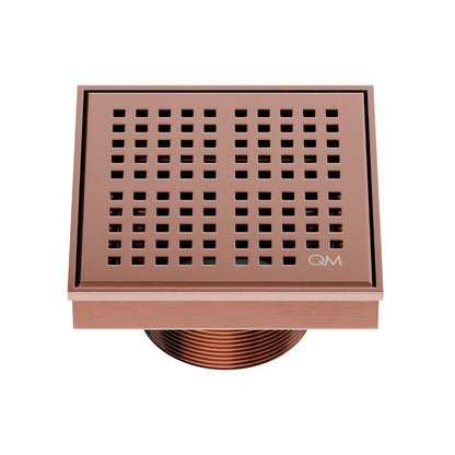 QM Drain Delmar Kai Square Drain 4x4-inch in Bronze finish, featuring a sleek stainless-steel grate with fine square perforations. This drain provides efficient water drainage, seamless tile integration, and an elegant aesthetic, ideal for luxury shower and bathroom floor installations.