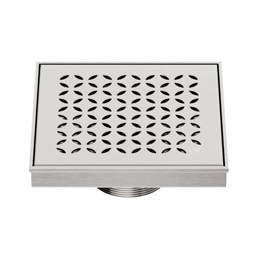 QM Drain Delmar Lotus Square Drain 5 3/4-inch in Satin finish, featuring a sleek stainless-steel channel with an elegant floral-pattern grate. This drain offers efficient water drainage, seamless tile integration, and a high-end polished aesthetic, ideal for luxury shower and bathroom floor installations.