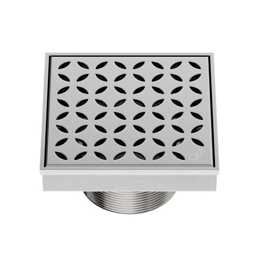 QM Drain Delmar Lotus Square Drain 4x4-inch in Satin finish, featuring a sleek stainless-steel channel with an elegant floral-pattern grate. This drain offers efficient water drainage, seamless tile integration, and a high-end polished aesthetic, ideal for luxury shower and bathroom floor installations.