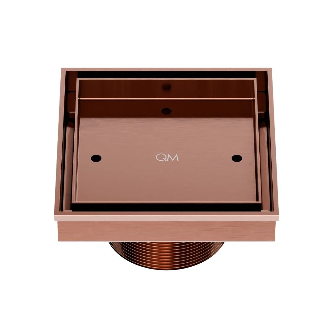 QM Drain Delmar Mist Tile-In Square Shower Drain 4x4-inch in Bronze finish, featuring a sleek stainless-steel channel with a 'mist' perforated grate design. This drain ensures seamless tile integration, efficient water drainage, and an elegant aesthetic for luxury shower and bathroom floor installations.